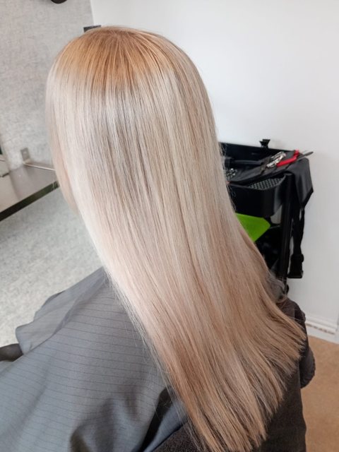 After: long, sleek pearl blonde by Homeward Halo hair salon in Radcliffe, Bury